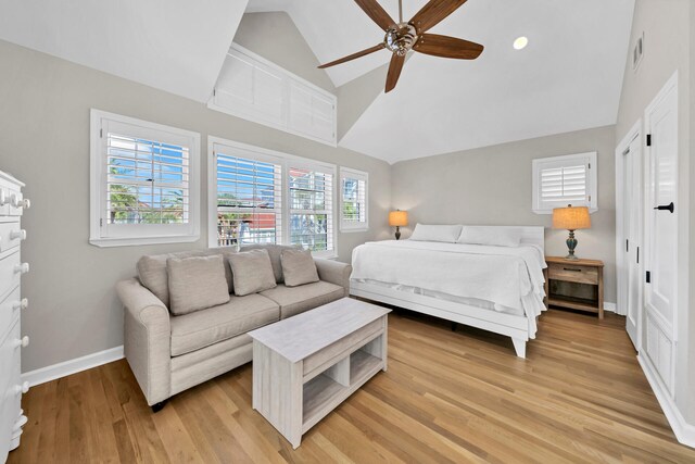 bedroom with vaulted ceiling, ceiling fan, and light hardwood / wood-style floors