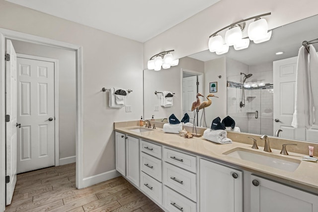 bathroom with vanity, wood-type flooring, and walk in shower