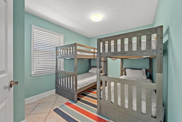 tiled bedroom with a textured ceiling