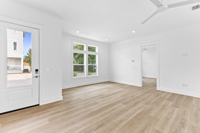 foyer entrance with light hardwood / wood-style flooring, ceiling fan, and crown molding