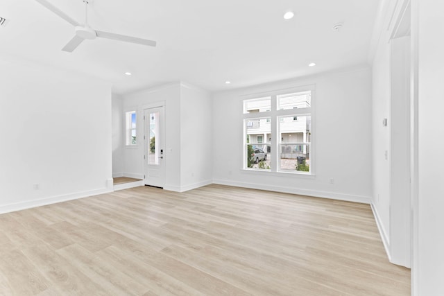 unfurnished living room with light hardwood / wood-style floors, ceiling fan, and crown molding