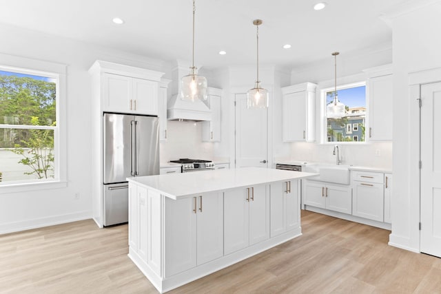 kitchen featuring a center island, sink, white cabinetry, and stainless steel appliances