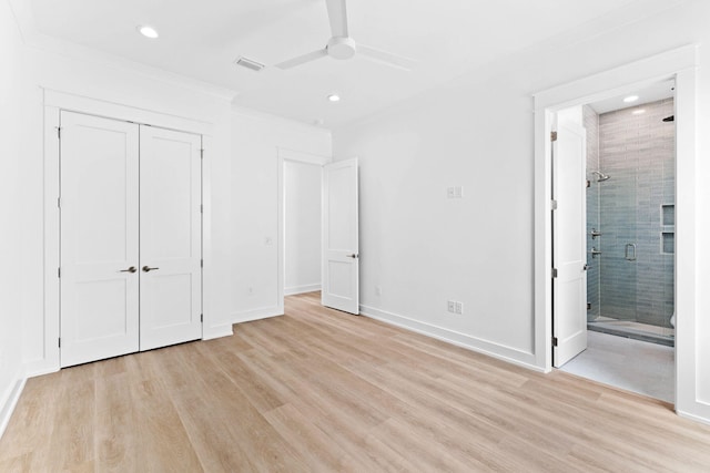 unfurnished bedroom with ensuite bathroom, ceiling fan, crown molding, light hardwood / wood-style floors, and a closet