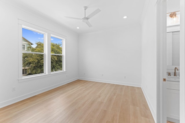 spare room featuring ceiling fan, light hardwood / wood-style flooring, sink, and ornamental molding