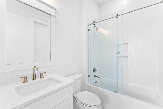 full bathroom featuring shower / bath combination with glass door, vanity, and toilet