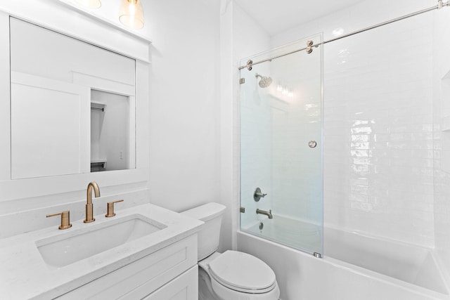 full bathroom featuring toilet, combined bath / shower with glass door, and vanity