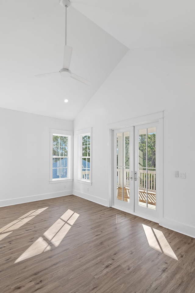 unfurnished room featuring ceiling fan, dark wood-type flooring, high vaulted ceiling, and french doors