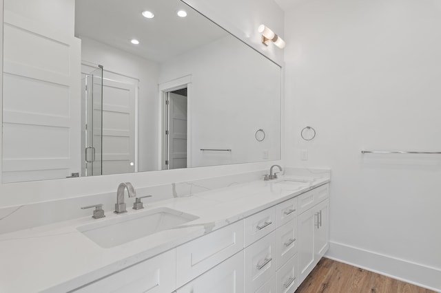 bathroom with hardwood / wood-style floors and vanity