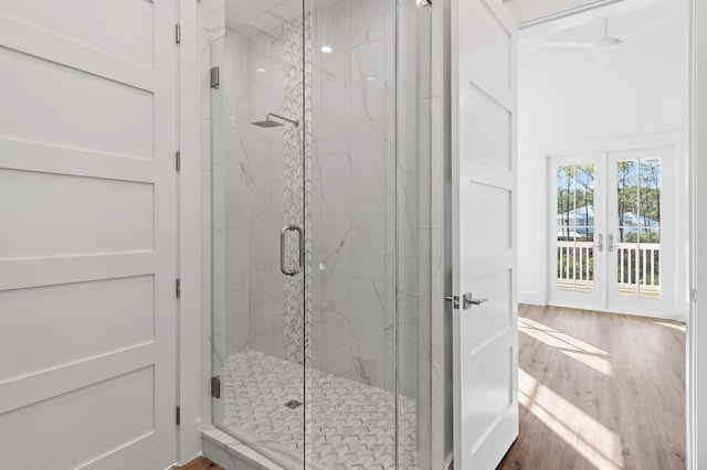 bathroom featuring wood-type flooring, french doors, walk in shower, and ceiling fan