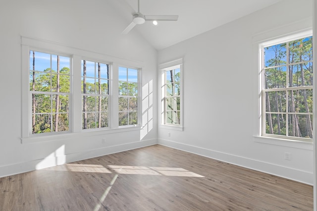 unfurnished sunroom featuring a wealth of natural light, ceiling fan, and vaulted ceiling