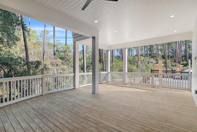 unfurnished sunroom with ceiling fan