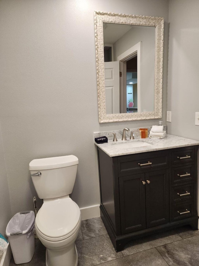 bathroom with tile patterned flooring, vanity, and toilet