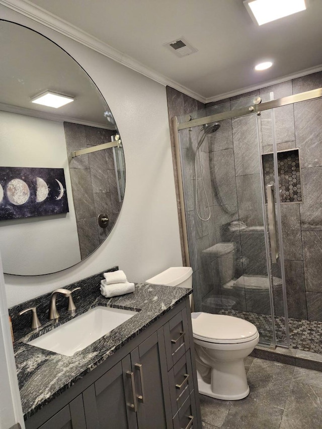 bathroom with crown molding, a shower with door, vanity, and toilet