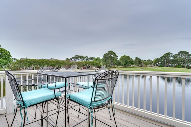 wooden terrace featuring a water view