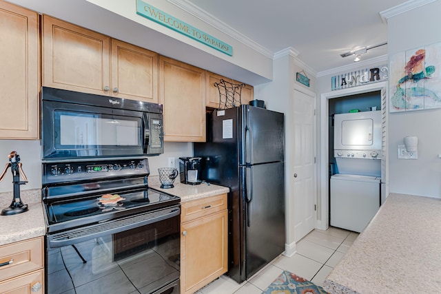 kitchen featuring crown molding, light tile patterned flooring, black appliances, and stacked washer / drying machine