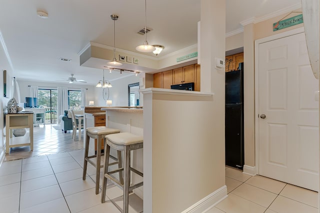 kitchen featuring light tile patterned floors, decorative light fixtures, ceiling fan, and black appliances