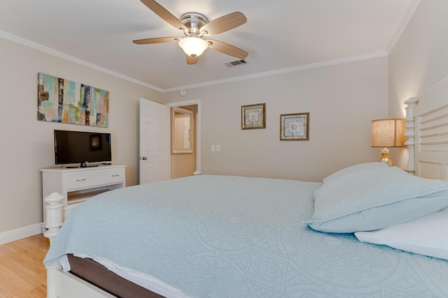 bedroom with ceiling fan, crown molding, and light hardwood / wood-style floors