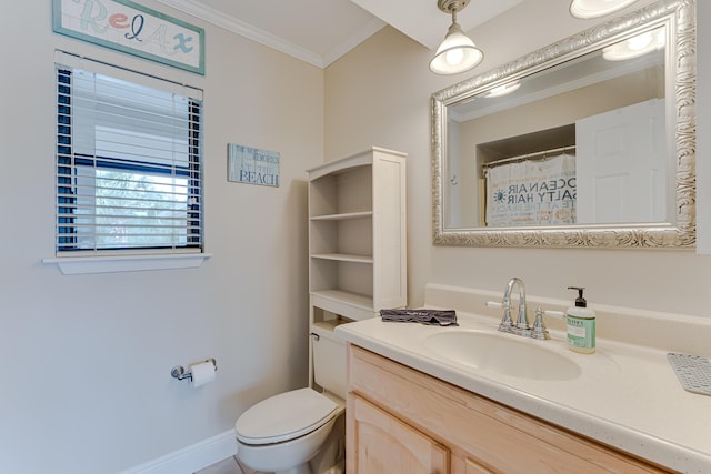 bathroom with crown molding, vanity, and toilet