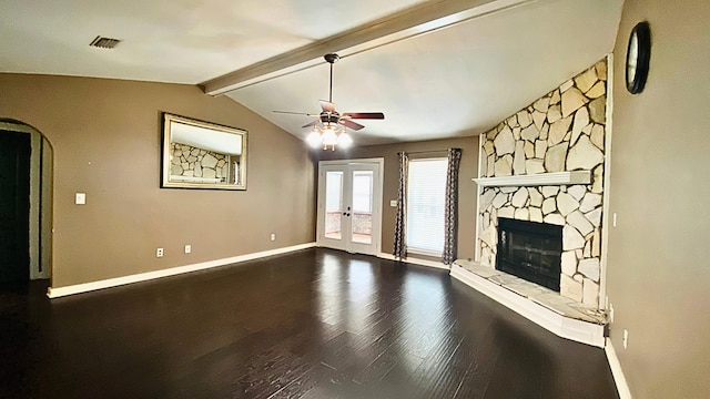 unfurnished living room with ceiling fan, french doors, lofted ceiling with beams, wood-type flooring, and a fireplace