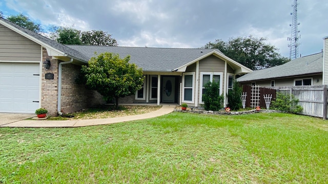 single story home featuring a front yard and a garage