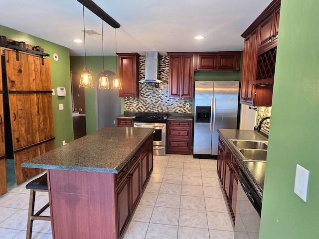 kitchen with a center island, wall chimney range hood, sink, a kitchen bar, and stainless steel appliances