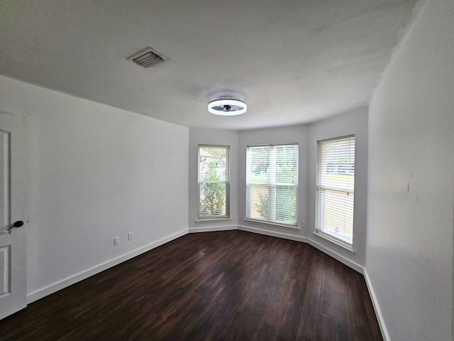 empty room with dark hardwood / wood-style floors