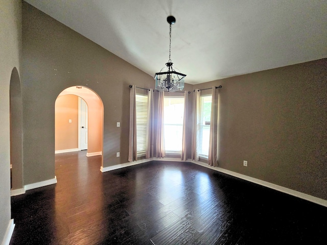 empty room with dark hardwood / wood-style floors, an inviting chandelier, and lofted ceiling