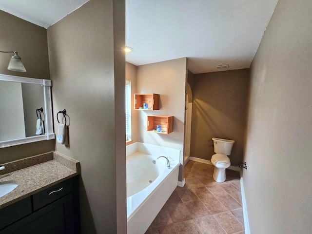 bathroom featuring vanity, a bathtub, and toilet