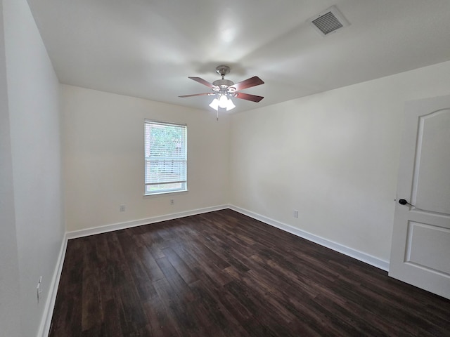 unfurnished room with ceiling fan and dark wood-type flooring