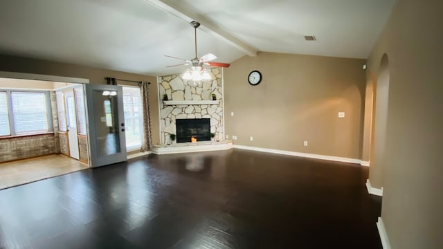 unfurnished living room featuring hardwood / wood-style floors, ceiling fan, a fireplace, and lofted ceiling with beams