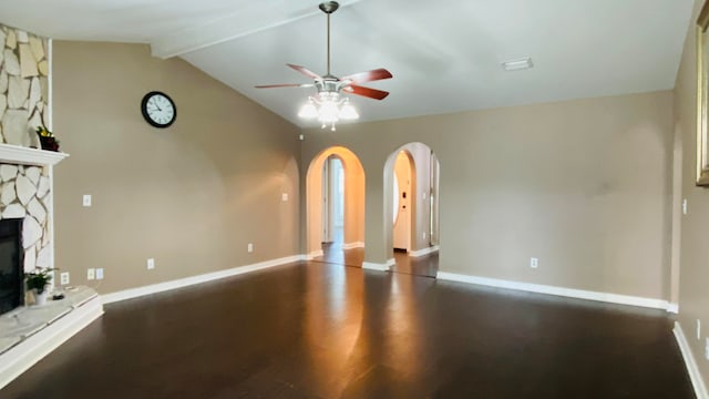 unfurnished living room with vaulted ceiling with beams, ceiling fan, a fireplace, and dark wood-type flooring