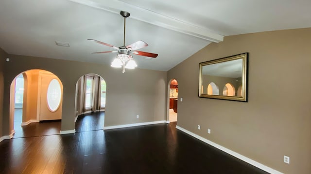 unfurnished living room featuring ceiling fan, dark hardwood / wood-style flooring, and lofted ceiling with beams