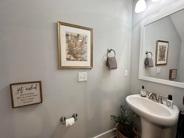 bathroom with sink and lofted ceiling