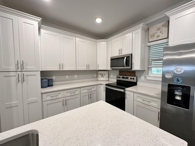 kitchen featuring white cabinetry, light stone countertops, and appliances with stainless steel finishes