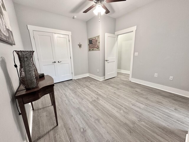 interior space featuring a closet, hardwood / wood-style flooring, and ceiling fan