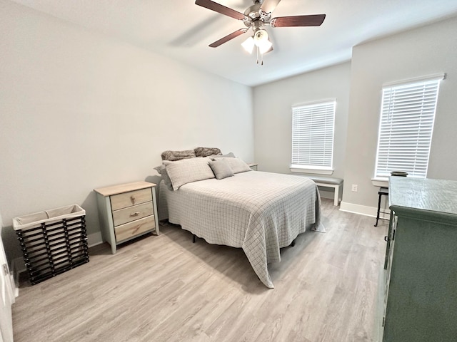 bedroom with ceiling fan and light hardwood / wood-style flooring