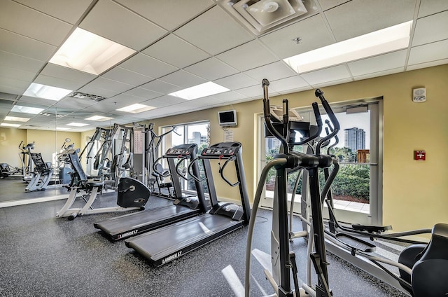 exercise room with a paneled ceiling