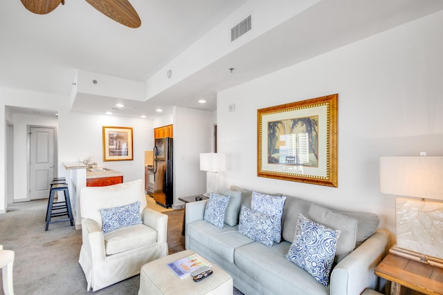 living room with light carpet, sink, and ceiling fan