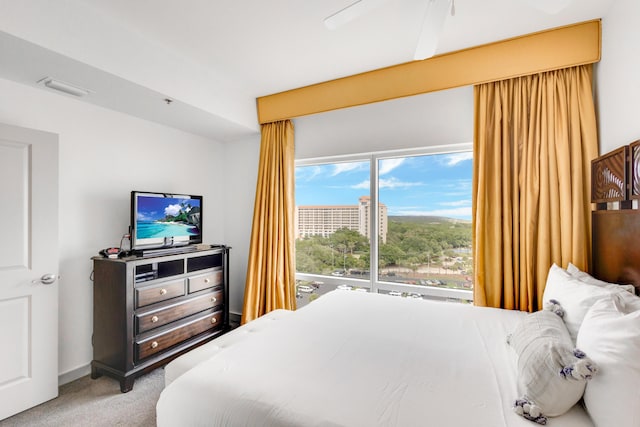 bedroom featuring multiple windows, carpet flooring, and ceiling fan