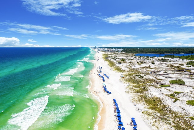 drone / aerial view featuring a view of the beach and a water view