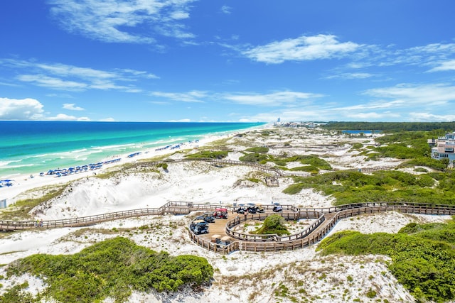 bird's eye view featuring a water view and a beach view