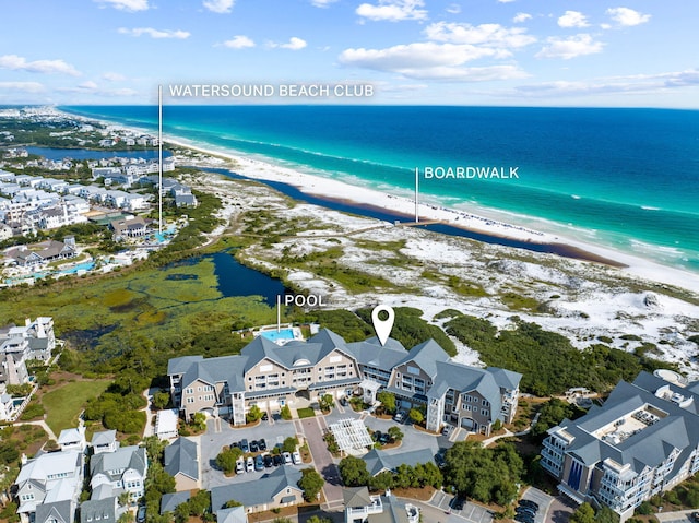 birds eye view of property with a view of the beach and a water view