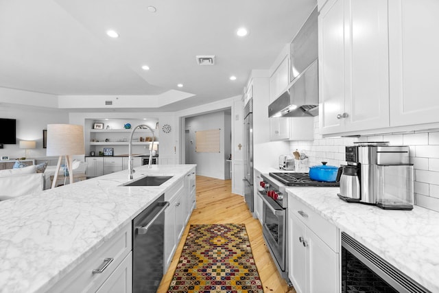37 S Compass Point Way Unit 107, Inlet Beach, FL 32461 - kitchen featuring premium appliances, wall chimney exhaust hood, open floor plan, light stone countertops, and recessed lighting