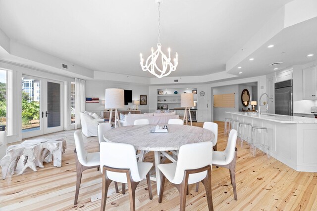 dining area featuring light wood-style flooring, a notable chandelier, recessed lighting, and visible vents