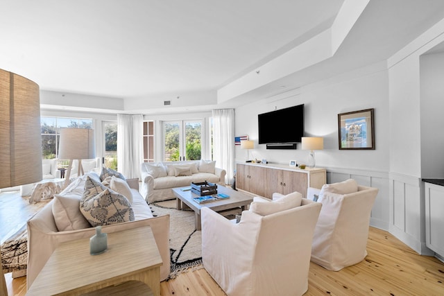 37 S Compass Point Way Unit 107, Inlet Beach, FL 32461 - living area featuring light wood-style flooring and a wainscoted wall