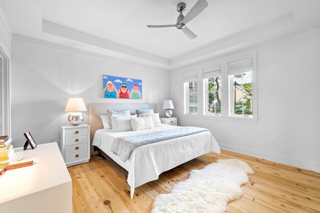 37 S Compass Point Way Unit 107, Inlet Beach, FL 32461 - bedroom with a tray ceiling, light wood finished floors, and ceiling fan