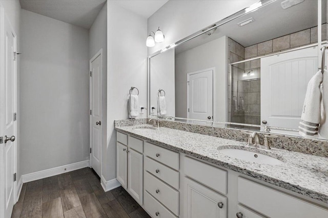 bathroom with a shower with door, vanity, and hardwood / wood-style flooring