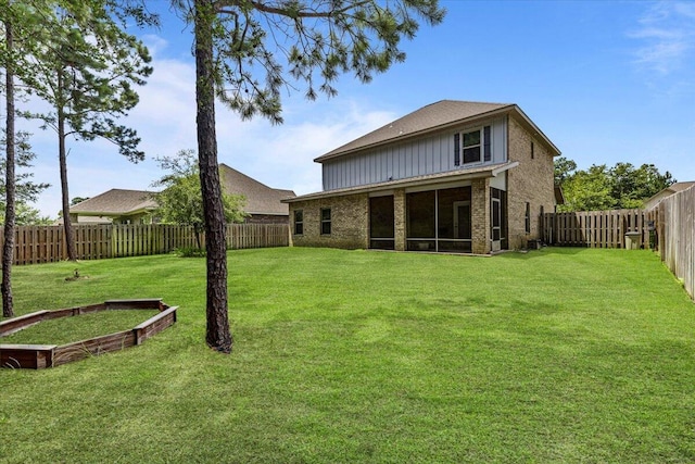 rear view of property featuring a yard