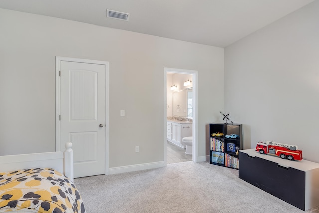 carpeted bedroom with ensuite bath