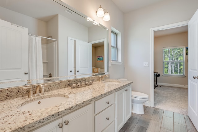 168 Secret St, Freeport, FL 32439 - full bathroom featuring toilet, double vanity, a shower with curtain, and baseboards